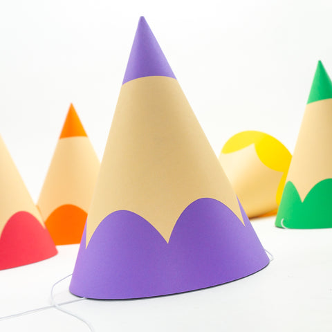 a traditional cone-shaped party hats that look just like colored pencils. The hat in the foreground is purple.
