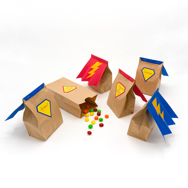 Superhero goodie bags. Mini paper bags with capes and shields. For filling with party favors.