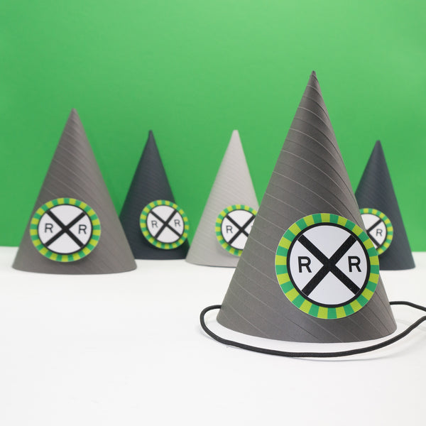 Gray party hat with embossed stripes and a railroad crossing sign on the front. The sign is bordered with a burst of green.