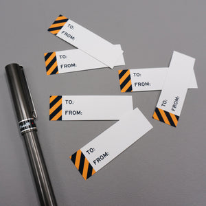 Rectangular to and from gift tag sticker labels with a black and orange warning stripe on the left side.