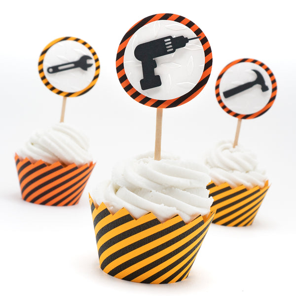 Black and orange striped cupcake wrappers to resemble caution tape. The top of the wrapper has a zig-zag edge. They are photographed on a cupcake which also has a decorative topper (sold separately).