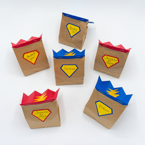 Superhero goodie bags. Mini paper bags with capes and shields. For filling with party favors.